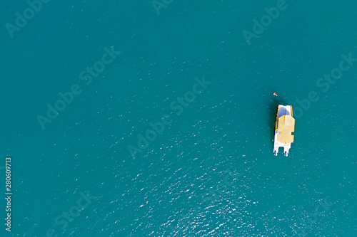 Aerial view of small boats on turquoise sea water.