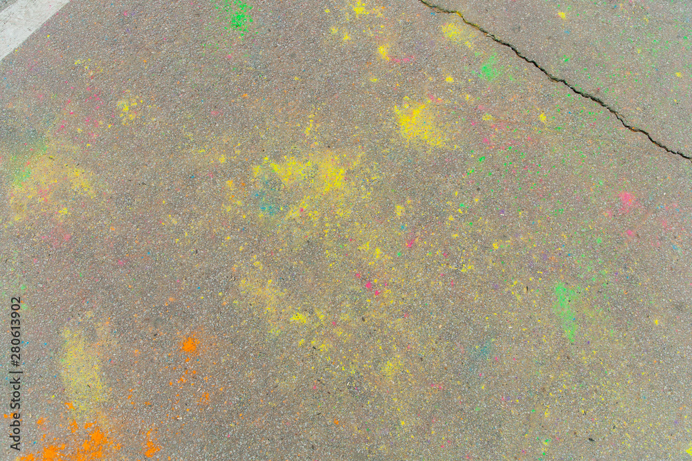 Holi colors scattered on asphalt after Holi festival