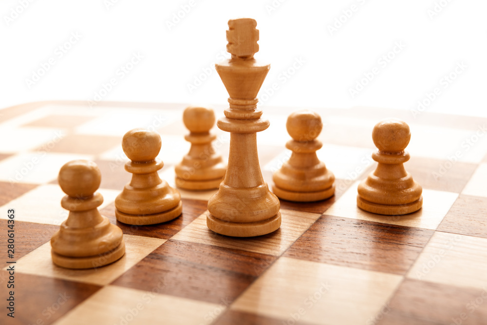 Chess piece of the white king surrounded by pawns Chess piece of the white king surrounded by pawns