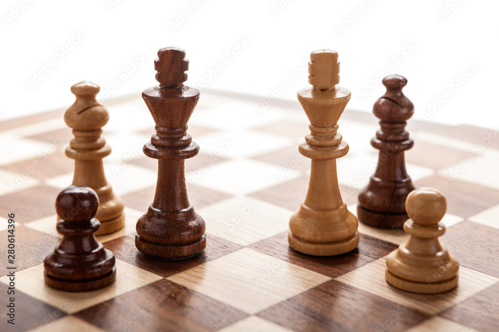 two wooden chess kings between other pieces two wooden chess kings between other pieces