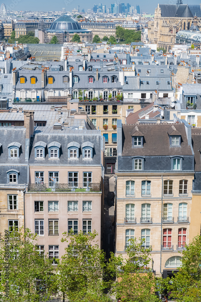 Paris, typical roofs in the Marais, aerial view with the Halles, the Saint-Eustache church and the Defense in background 