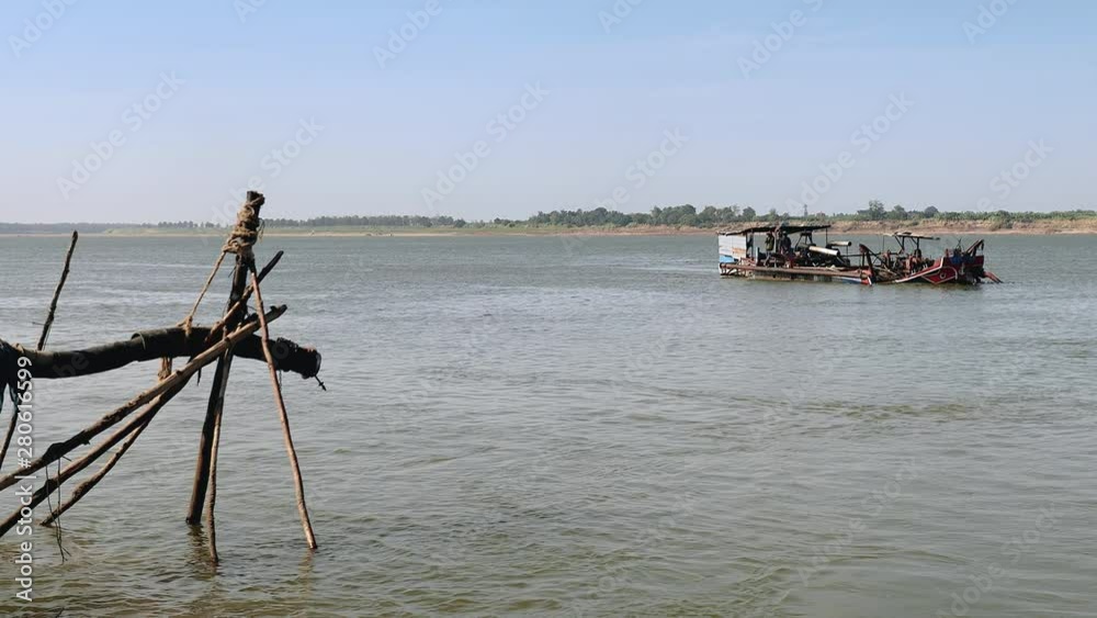 dredging boat filled with riverbed sand reaching the riverside dredging boat filled with riverbed sand reaching the riverside