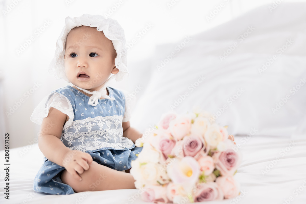 thai baby girl on white bed in bedroom and rose flower foreground vintage style thai baby girl on white bed in bedroom and rose flower foreground vintage style