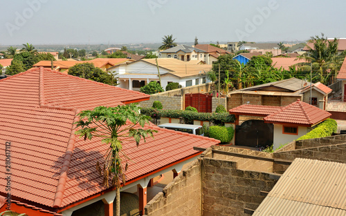 Red roofs of residential buildings in Africa. Modern view. Suburb lifestyle in developing countries. Beautiful urban landscape. Top view.