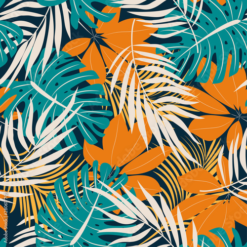 Original trend seamless pattern with bright tropical leaves and plants on a dark background. Vector design. Jungle print. Floral background. Printing and textiles. Exotic tropics. Summer design.
