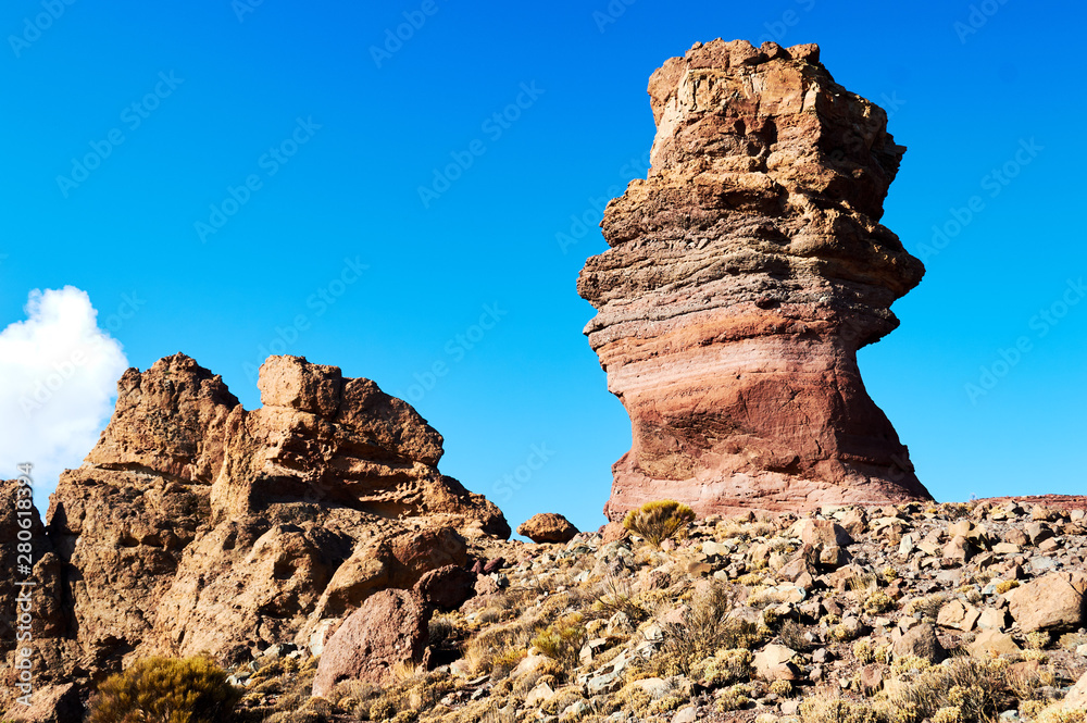 Fototapeta premium big high old stone in the desert with blue sky on the background