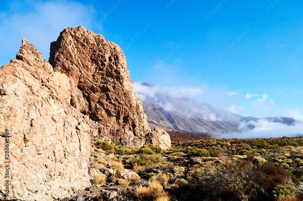 big rocks and yellow stones in the desert landscape with mountains and clouds on the background big rocks and yellow stones in the desert landscape with mountains and clouds on the background