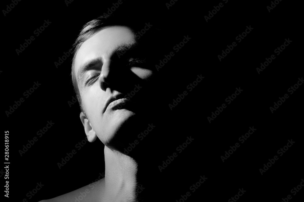 black and white photo, large portrait half face lit black and white photo, large portrait half face lit