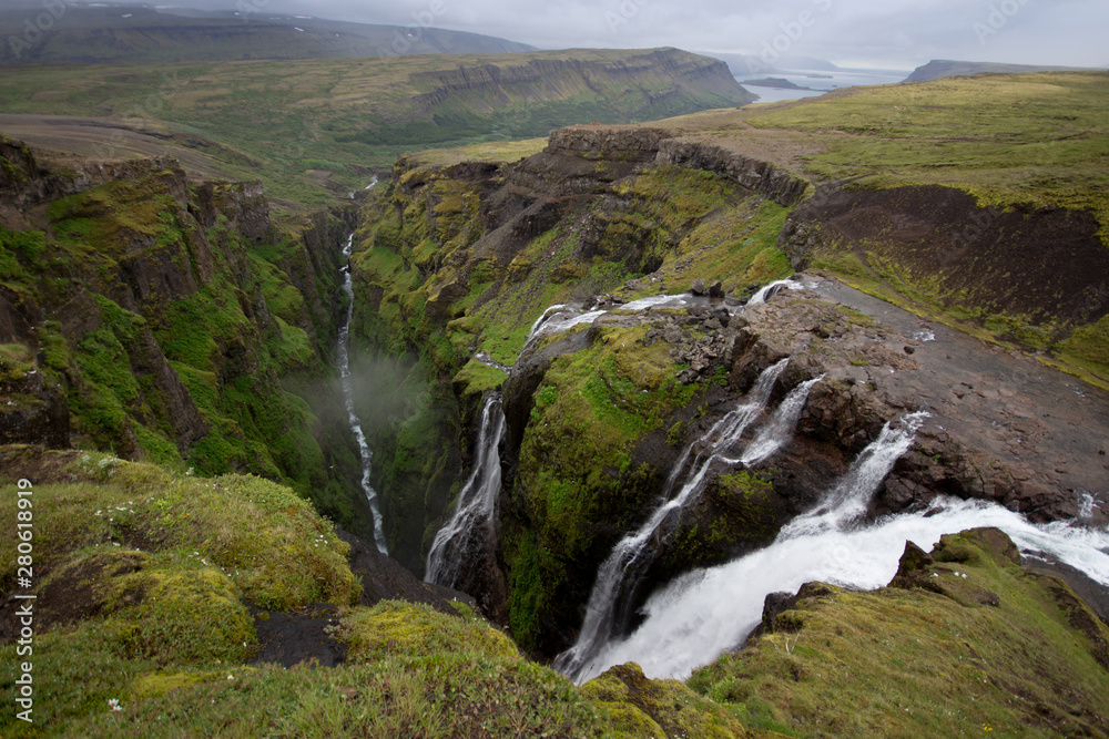 View from the top of Glymur waterfall. Green hills, high waterfall. Iceland View from the top of Glymur waterfall. Green hills, high waterfall. Iceland
