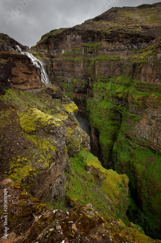 View of Glymur waterfall. Green hills, high waterfall. Iceland