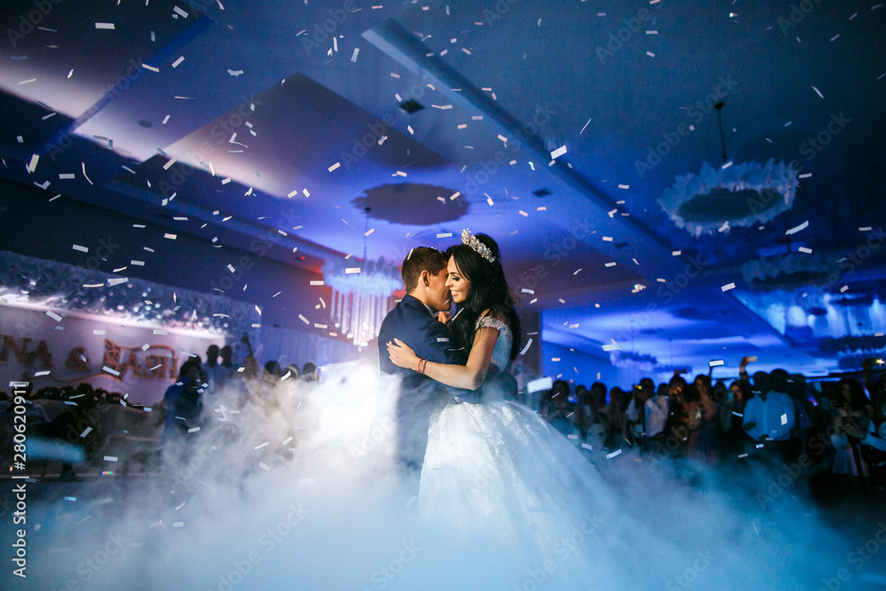 newlyweds dancing the first wedding dance in a restaurant - obrazy, fototapety, plakaty 