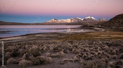 Lake Lago Chungar·, red evening sky, Nevados de Quimsachata, Uqi Uqini volcano, altitude 5532m, Cerro Umurata altitude 5517m, Lauca National Park, Putre, Parinacota province, RegiÛn de Arica y Parinacota, Chile, South America photo