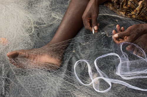 Fisherman mending a fishing net, Kerala, India, Asia