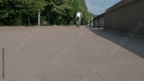 Wallpaper Mural man an athlete, gets on his bike and drives away from the camera in no focus. Torontodigital.ca
