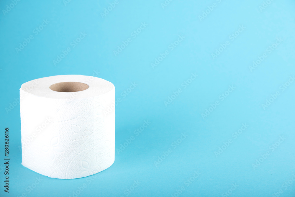 A roll of white toilet paper on a colored background. Space for text A roll of white toilet paper on a colored background. Space for text