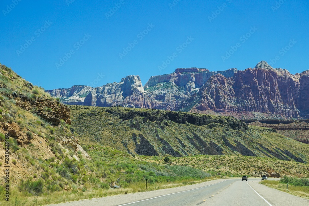 Fototapeta premium driving by green hills and cliffs