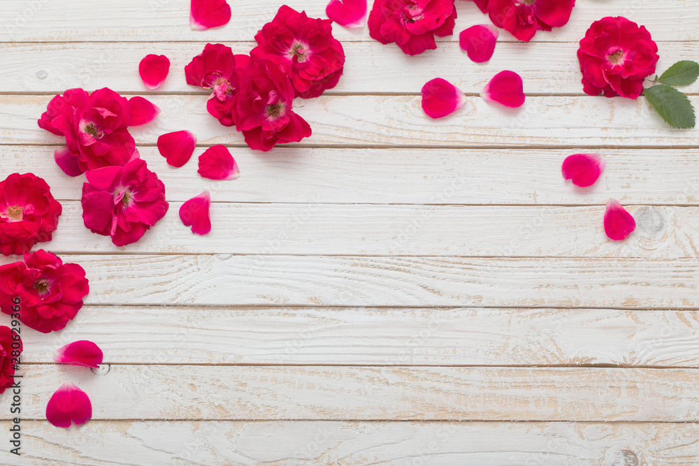 red roses on white wooden background red roses on white wooden background