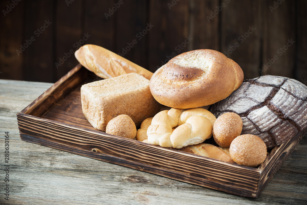 different types of bread on wooden background