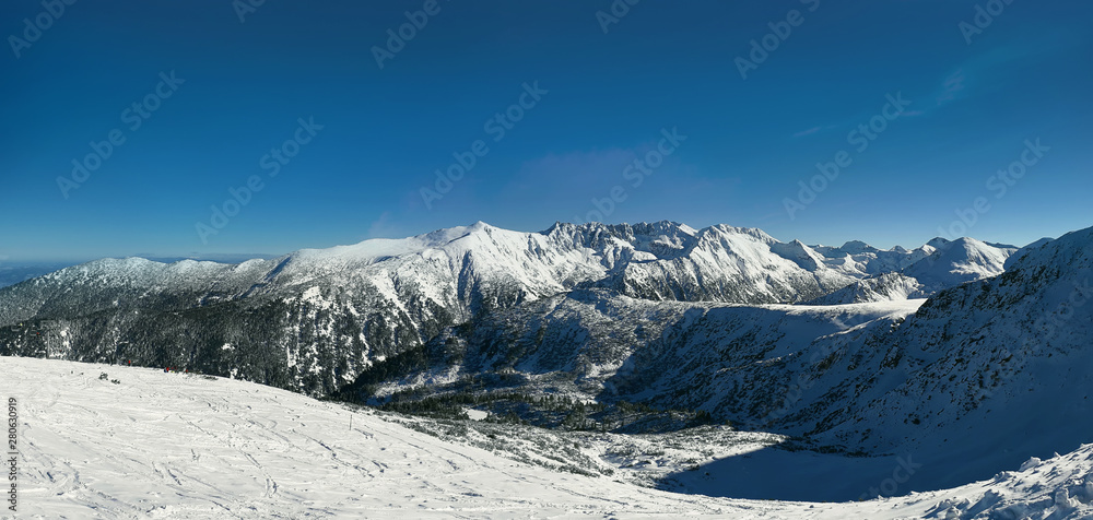 Snow covered Pirin mountains winter panorama.