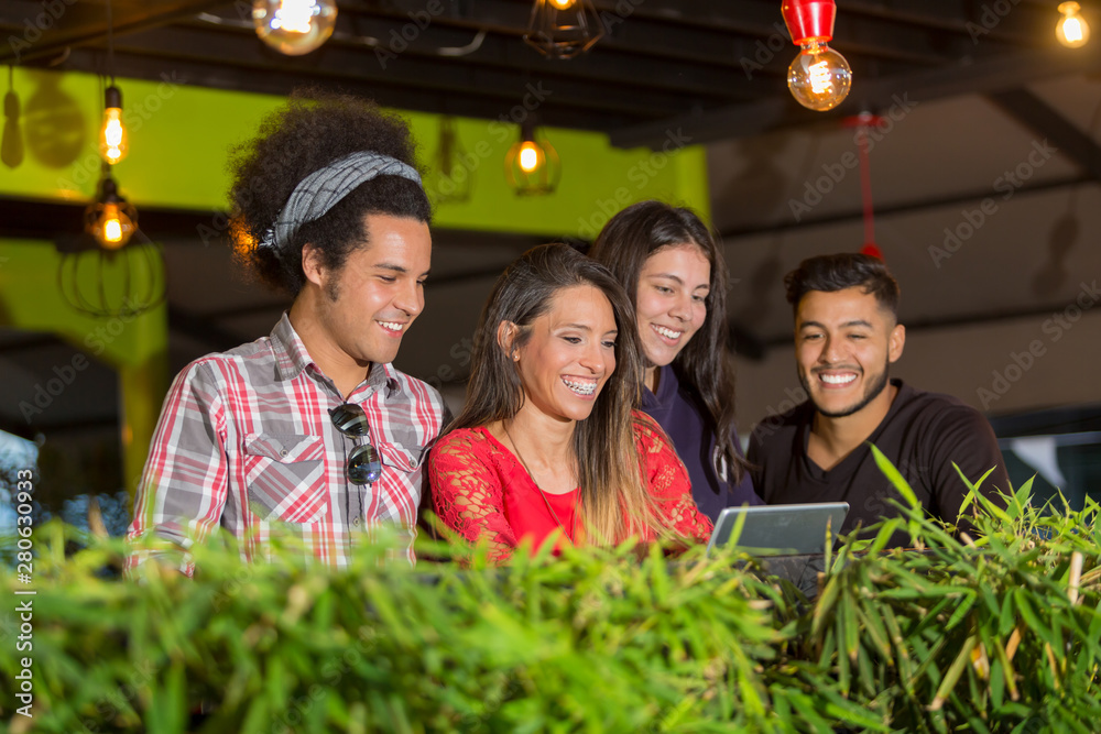 Young professionals are working outside the office at at cafe. They are using a smartphone and a tablet. They are is smiling. Young professionals are working outside the office at at cafe. They are using a smartphone and a tablet. They are is smiling.