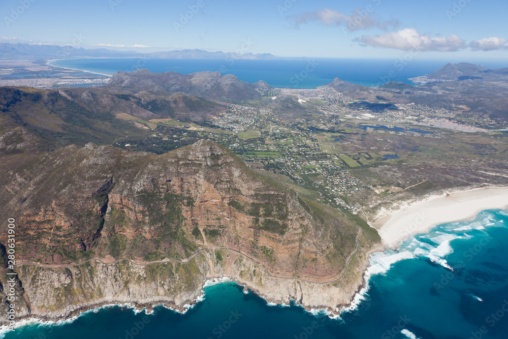 Aerial view of Cape point with lighthouse and Cape of Good Hope from a helicopter. Panorama of South Africa from birds eye view on a sunny day. Edge of the earth from helicopter view.