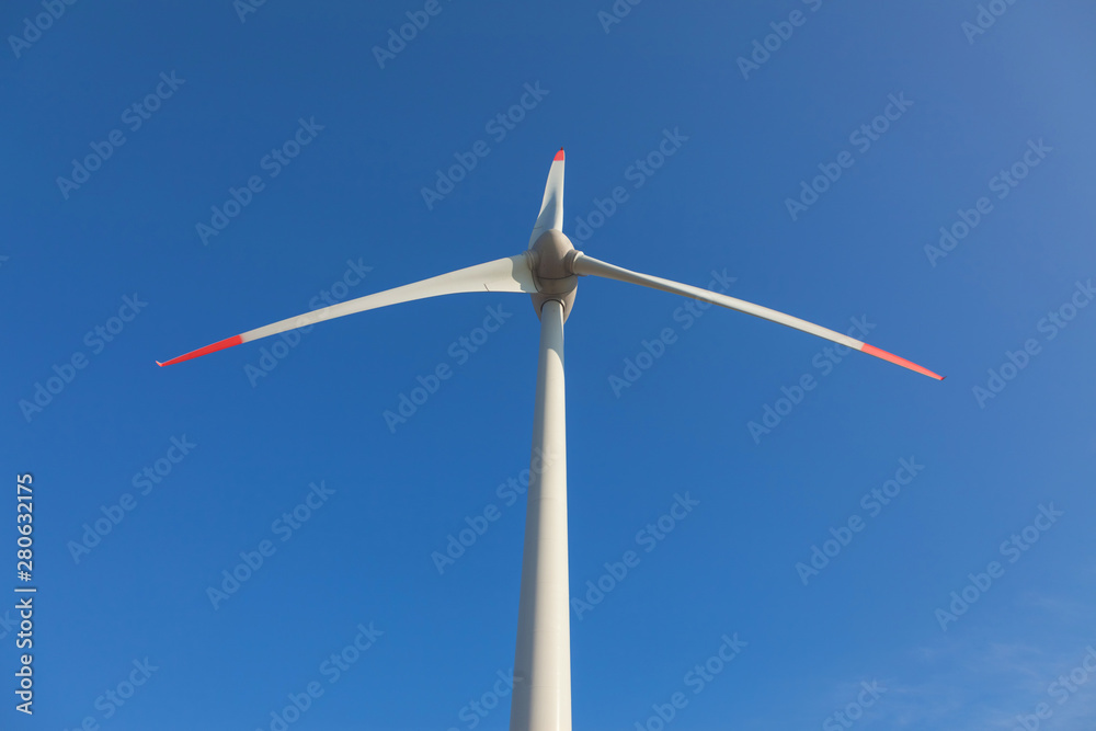 wind turbine with sun flare blue sky background view from below wind turbine with sun flare blue sky background view from below