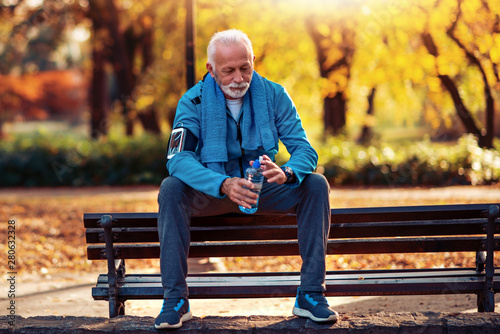 Senior man resting on bench in park