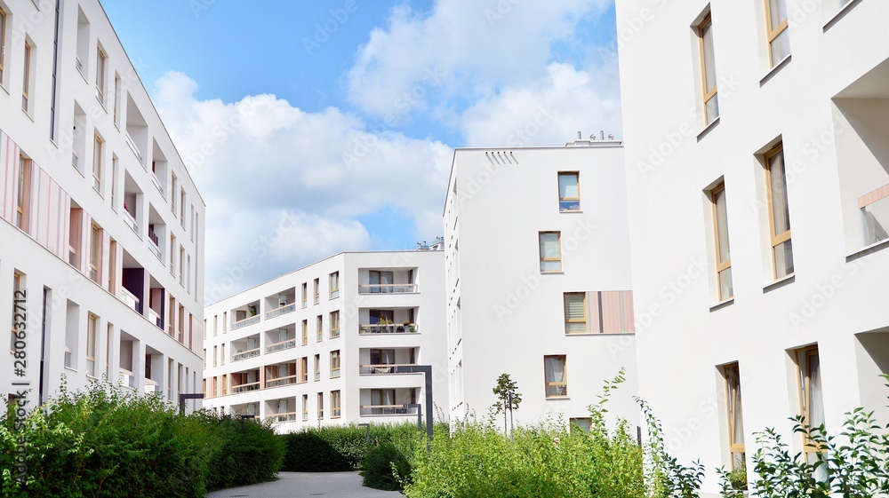 Fototapeta premium Modern multi-storey luxury housing concept. Modern apartment building with blue sky and clouds.
