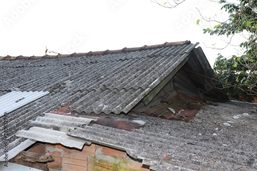 Photography Old roof damaged by strong winds of a thunderstorm