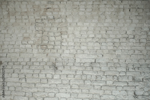 Light white or grey brick wall. Texture wallpaper background. Dirty old wall. Vintage structure.