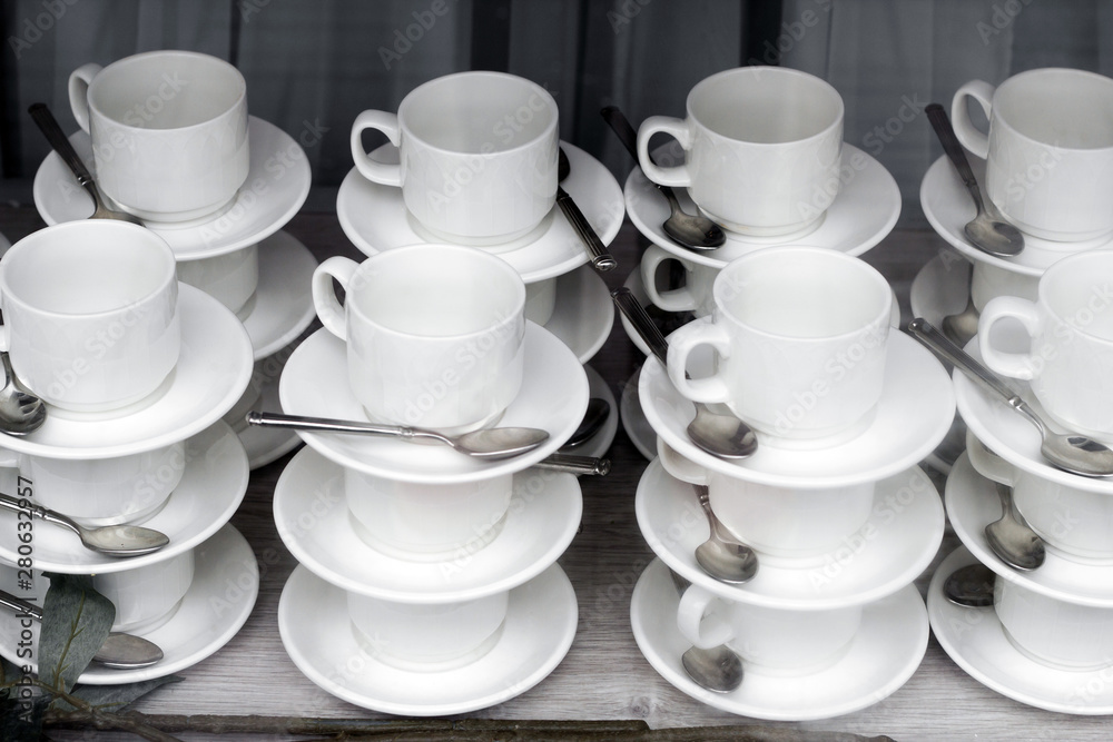 pattern of pairs of mugs and plates with spoons in the window of the tableware store