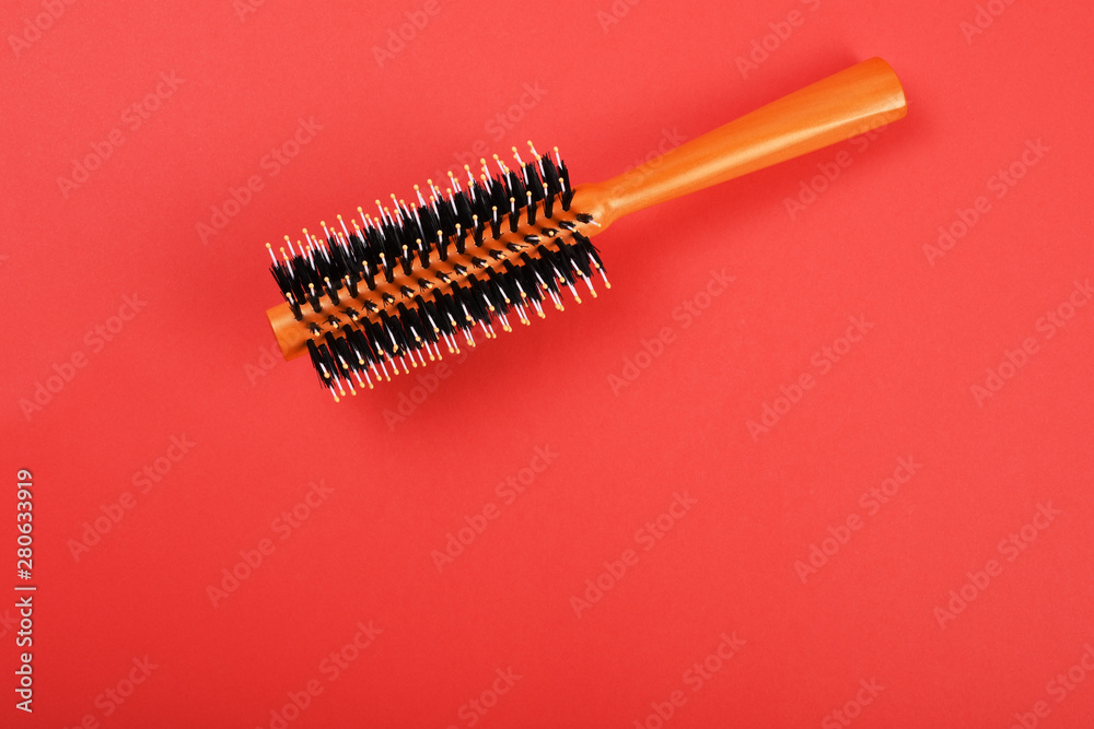 Hairbrush on the red background Hairbrush on the red background