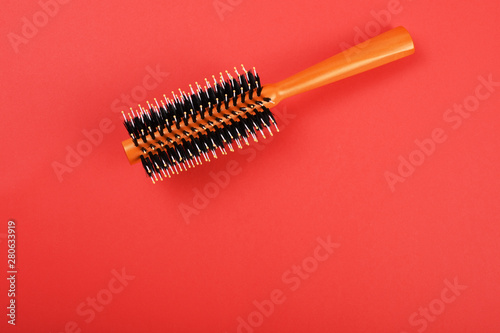 Hairbrush on the red background