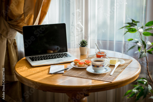business breakfast , coffee and caviar sandwiches. Cup of coffee with a laptop © freepeoplea