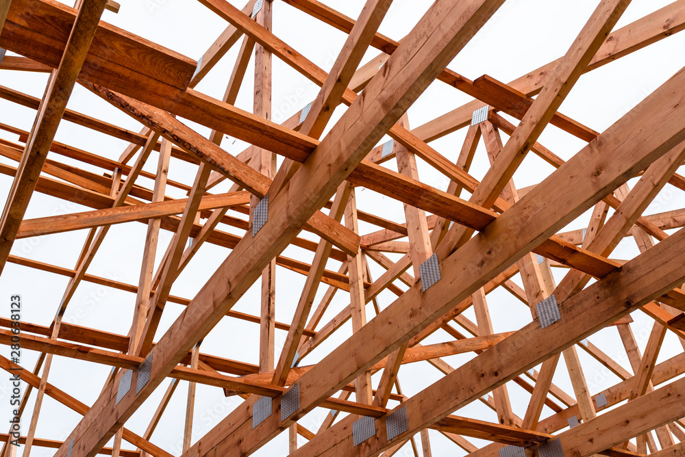 Roof trusses not covered with ceramic tile on a detached house under construction, visible roof elements, battens, counter battens, rafters.