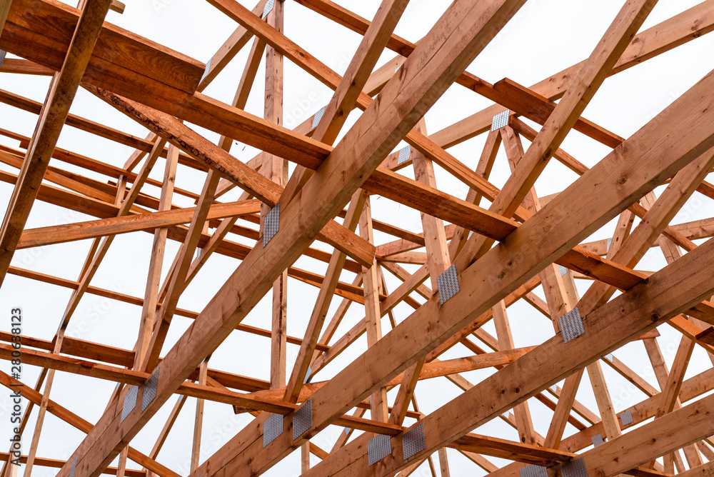 Roof trusses not covered with ceramic tile on a detached house under construction, visible roof elements, battens, counter battens, rafters. Roof trusses not covered with ceramic tile on a detached house under construction, visible roof elements, battens, counter battens, rafters.