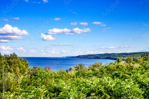 Beautiful landscape of Kaniv Reservoir, Ukraine, in sunny day with bright cloudy sky © tynza