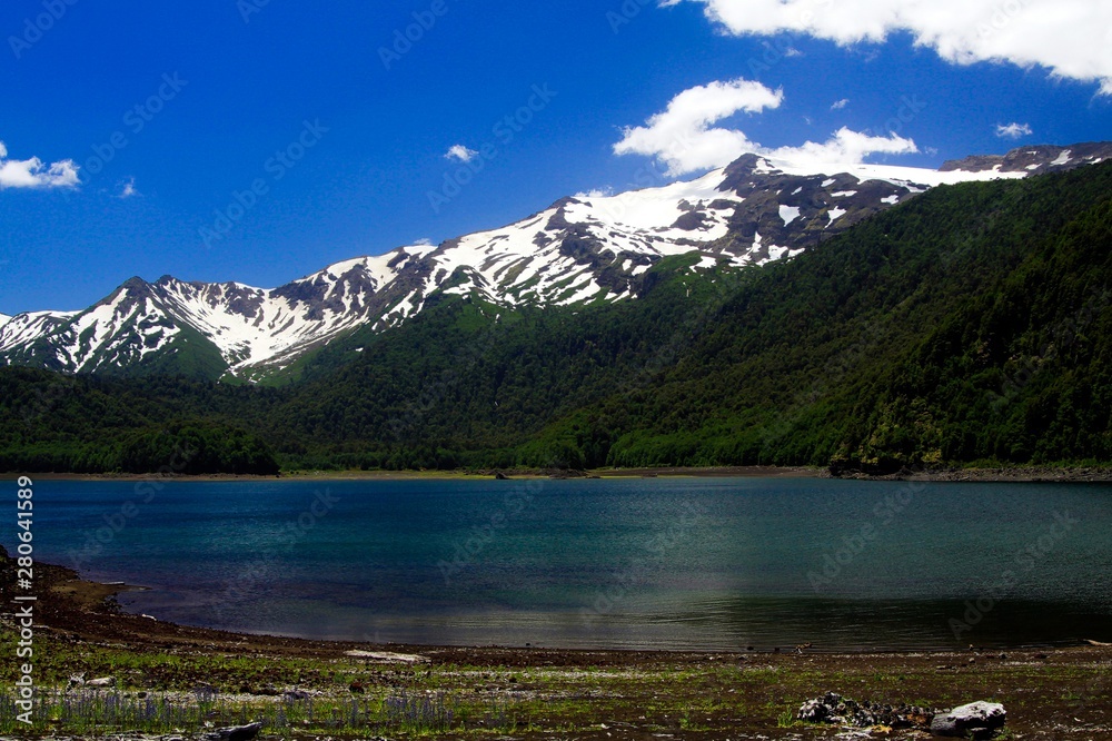 Volcano Llaima at Conguillio NP in central Chile - View over the lake on black peak with isolated spots of snow