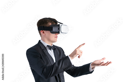 Serious businessman in VR glasses gesturing