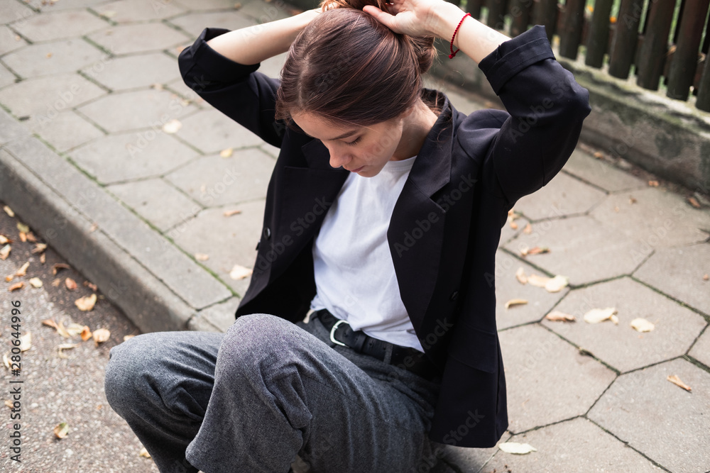 beautiful sweet girl sitting on the pavement beautiful sweet girl sitting on the pavement