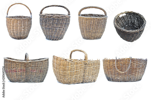 A variety of different old wicker baskets on an isolated white background.