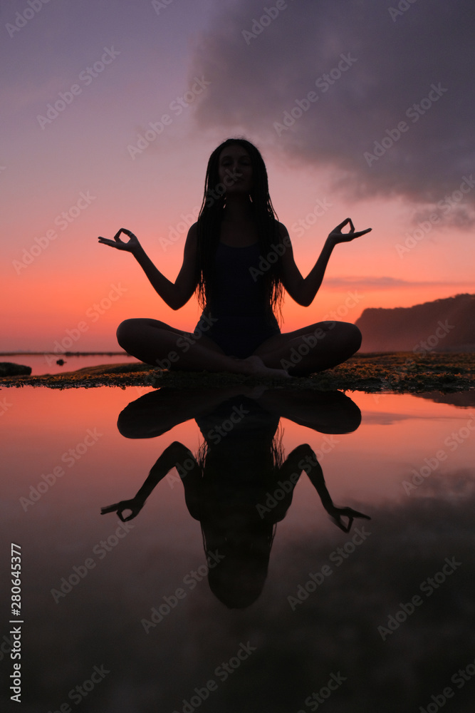 Silhouette young woman practicing yoga on the beach at sunset Stock ...