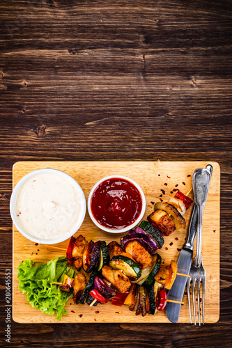 Kebabs - grilled meat and vegetables on cutting board