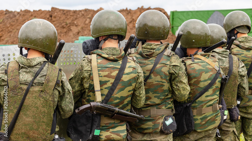 Military police behind a wall of shields photo