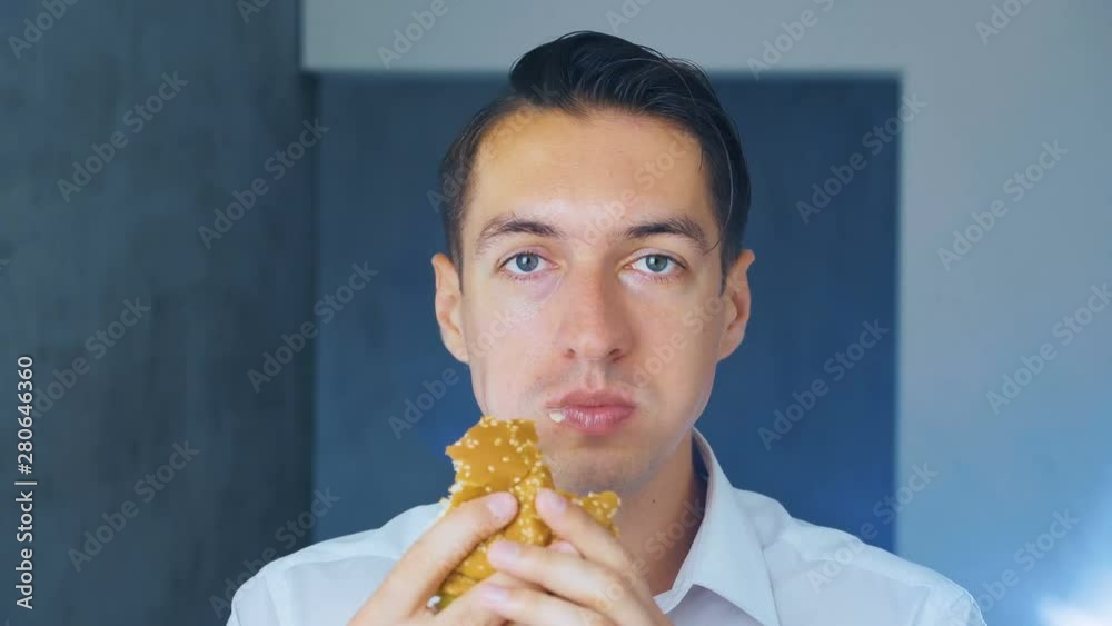 Timelapse of man eating a hamburger. Fast food. Cheeseburger, hamburger, sandwich.