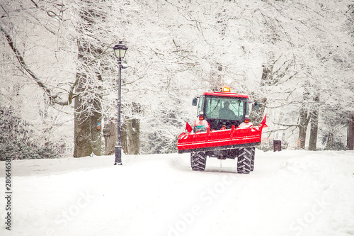 tractor cleans road from snow in the winter