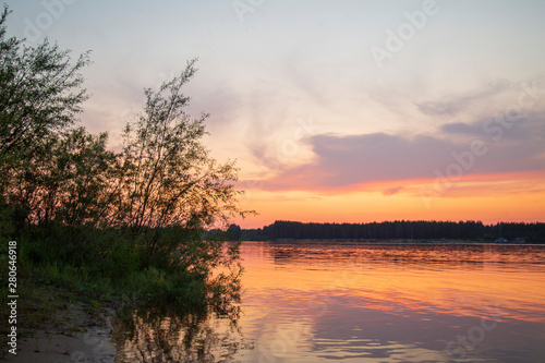 Beautiful summer landscape with sunset on the river. © Александр Поташев