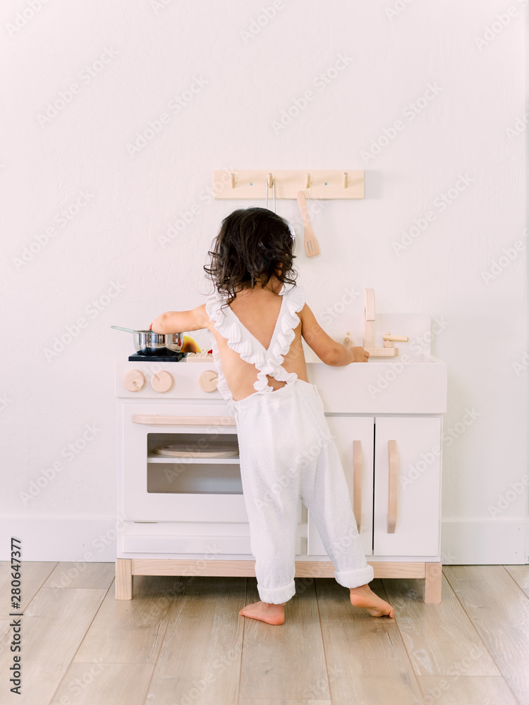 Toddler playing with play kitchen Toddler playing with play kitchen