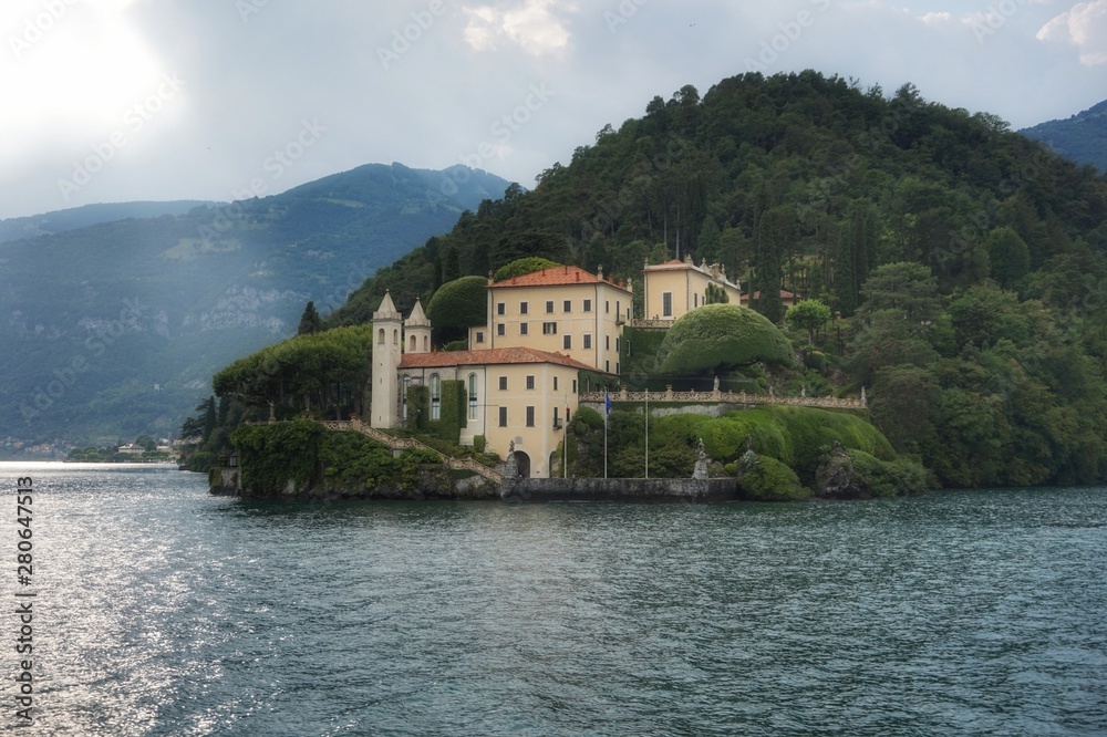 View of the Villa del Balbianello in the city of Lenno in the rays of the setting sun.
