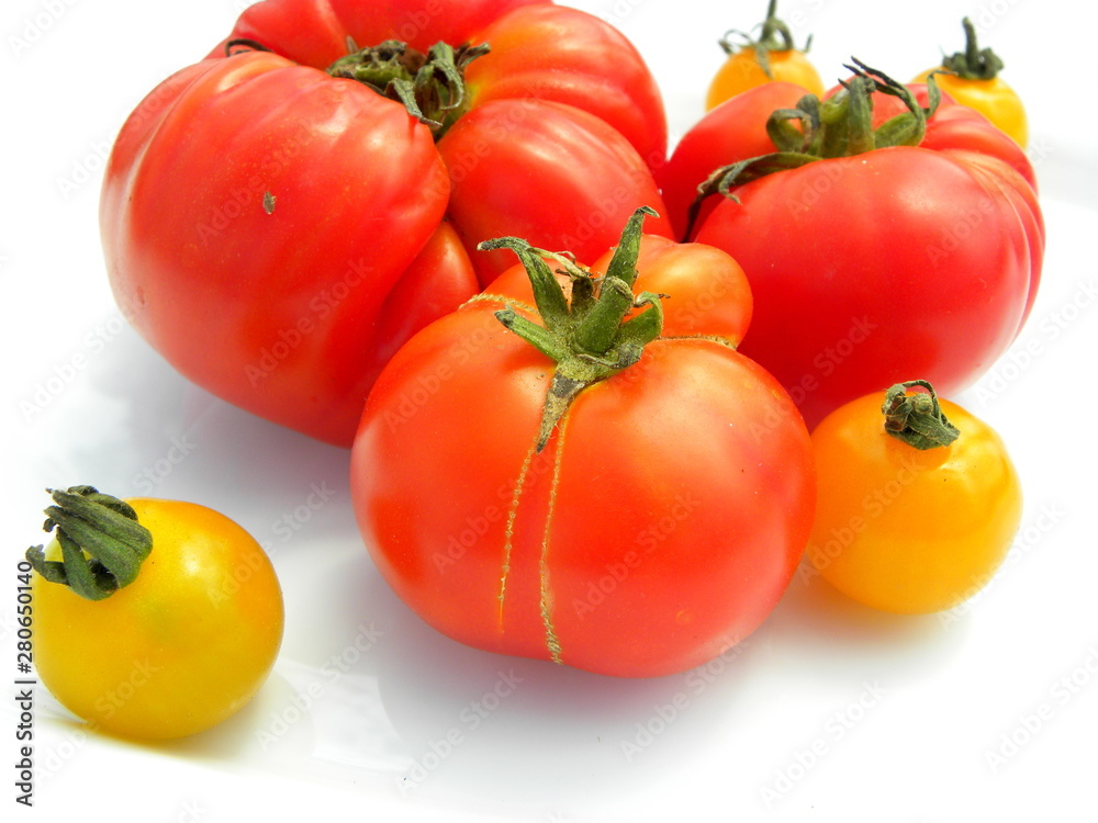 fresh red tomatoes on white background. yellow cherry tomatoes